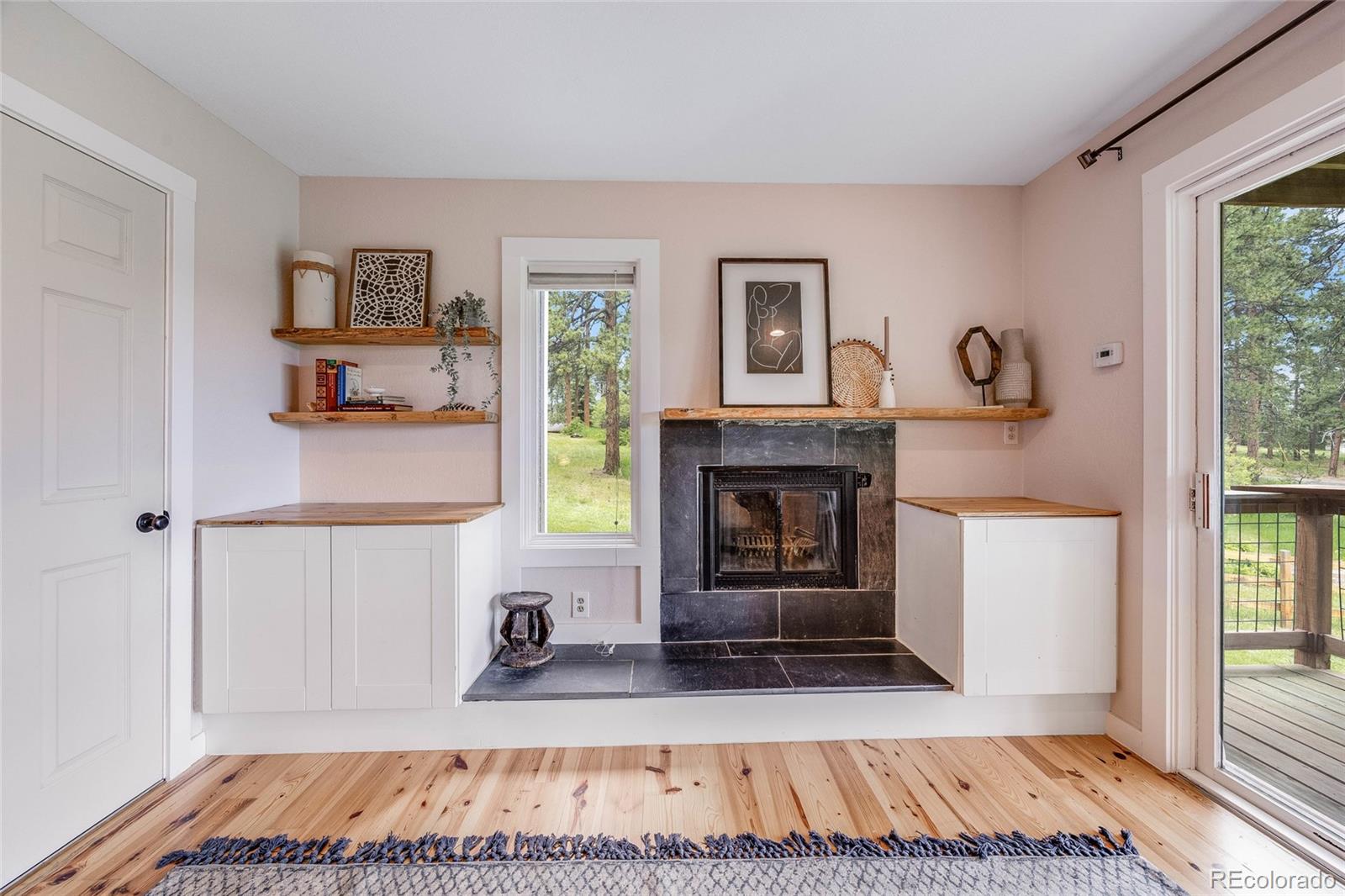 8783 Ault Lane Morrison, CO 80465 - Photo 24 of 40 a living room with furniture and a fireplace
