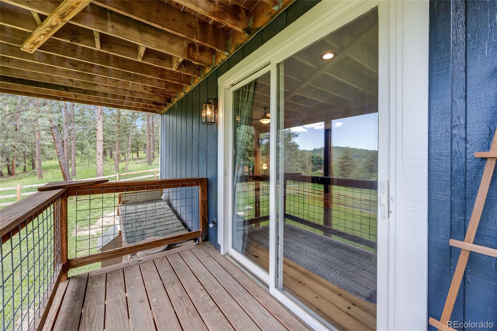 8783 Ault Lane Morrison, CO 80465 - Photo 25 of 40 a view of a balcony with wooden floor