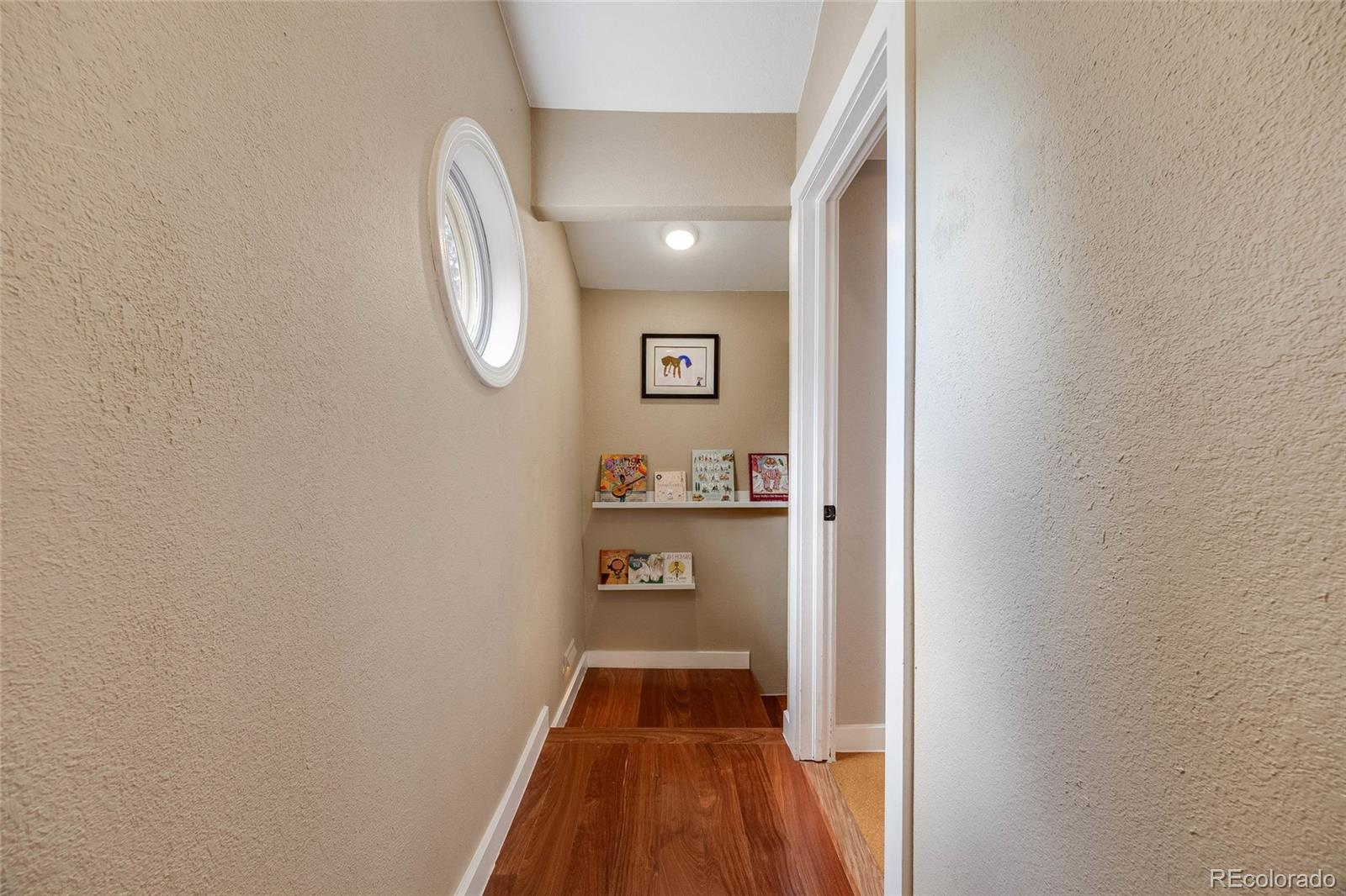 8783 Ault Lane Morrison, CO 80465 - Photo 29 of 40 a view of a hallway with wooden floor and entryway