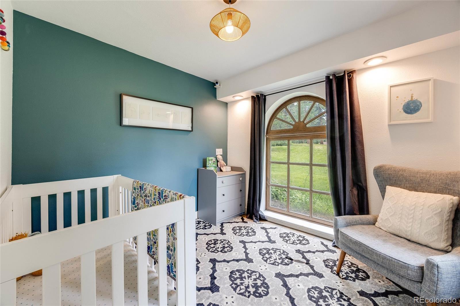 8783 Ault Lane Morrison, CO 80465 - Photo 34 of 40 a bedroom with furniture and a window