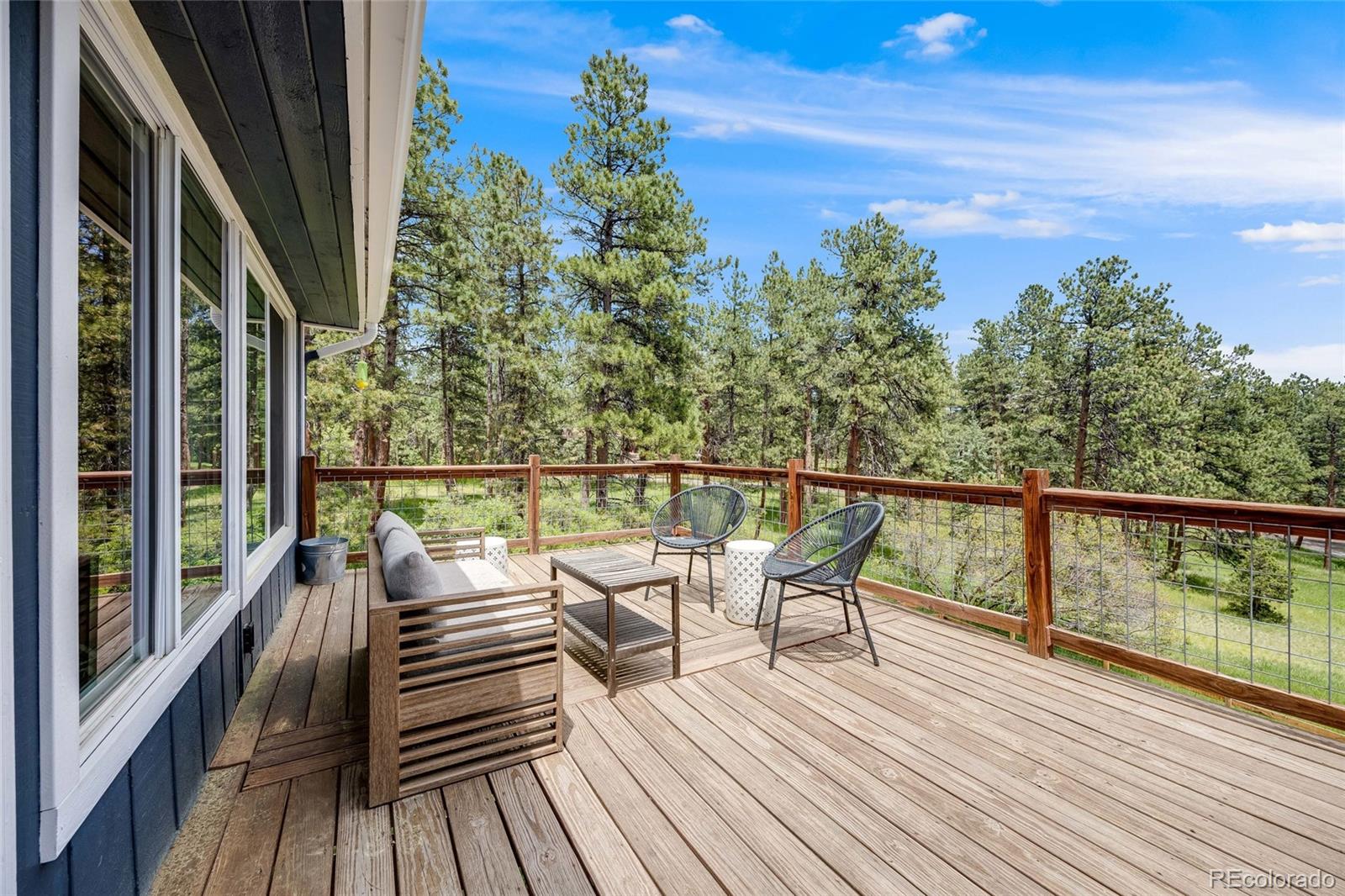 8783 Ault Lane Morrison, CO 80465 - Photo 38 of 40 a view of balcony with wooden floor and fence