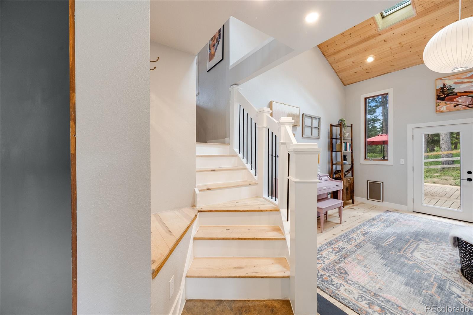 8783 Ault Lane Morrison, CO 80465 - Photo 7 of 40 a view of a hallway with windows and couches