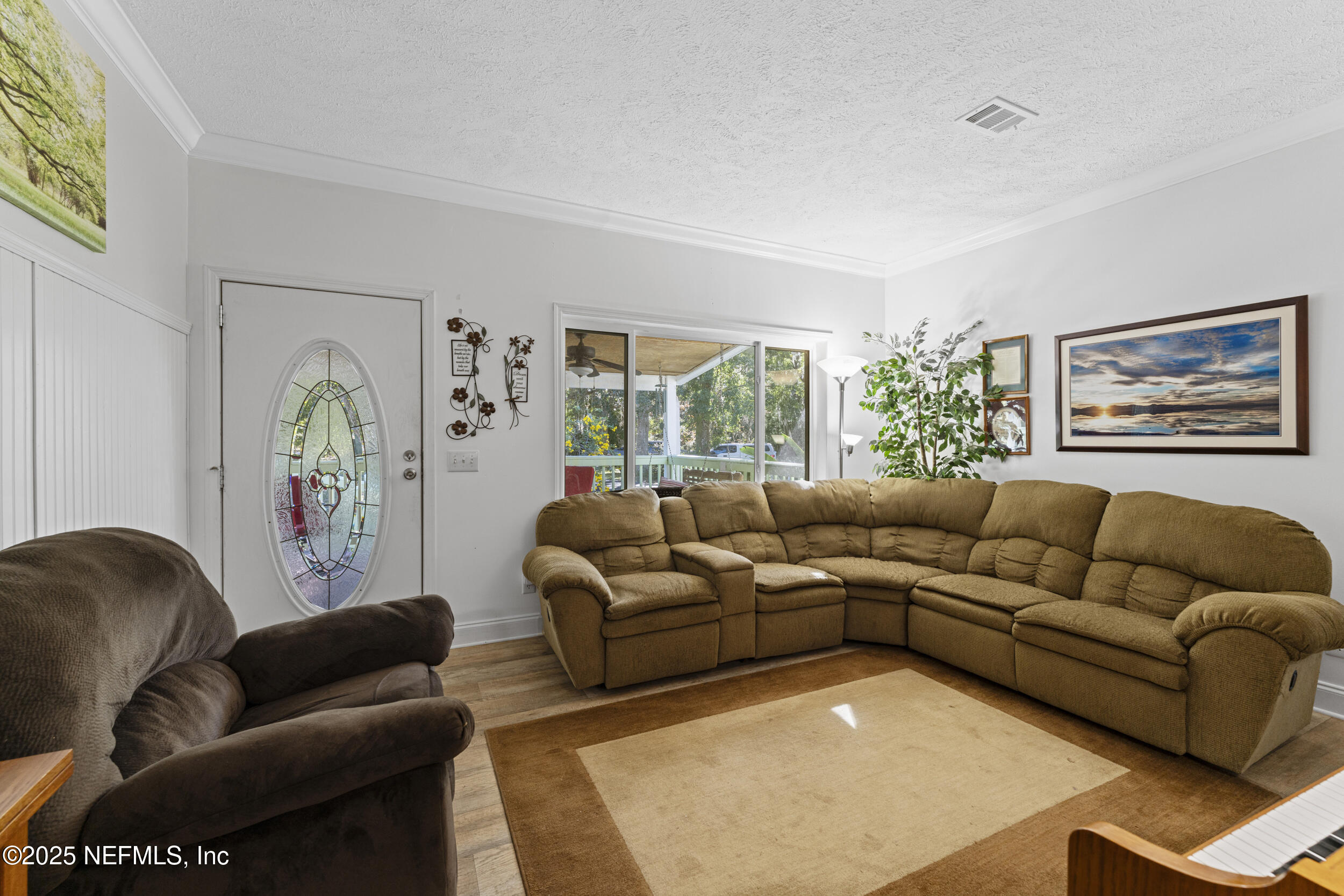 1463 Bardin Road Palatka, FL 32177 - Photo 15 of 61 a living room with furniture and a large window