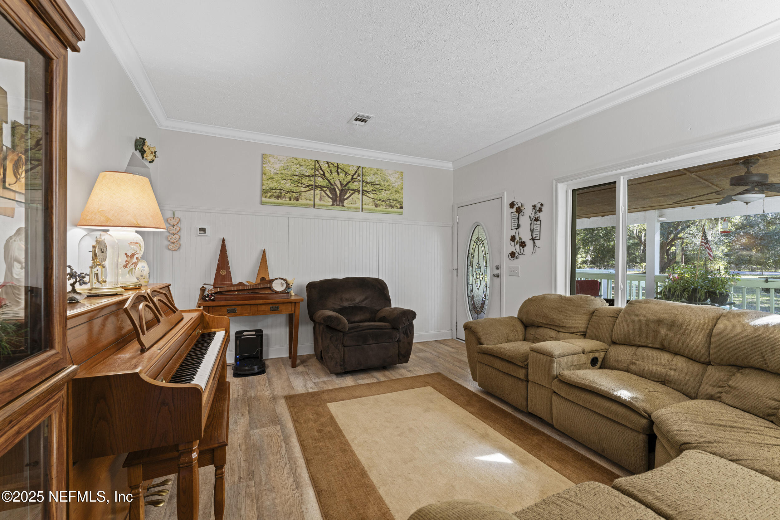 1463 Bardin Road Palatka, FL 32177 - Photo 16 of 61 a living room with furniture and a flat screen tv