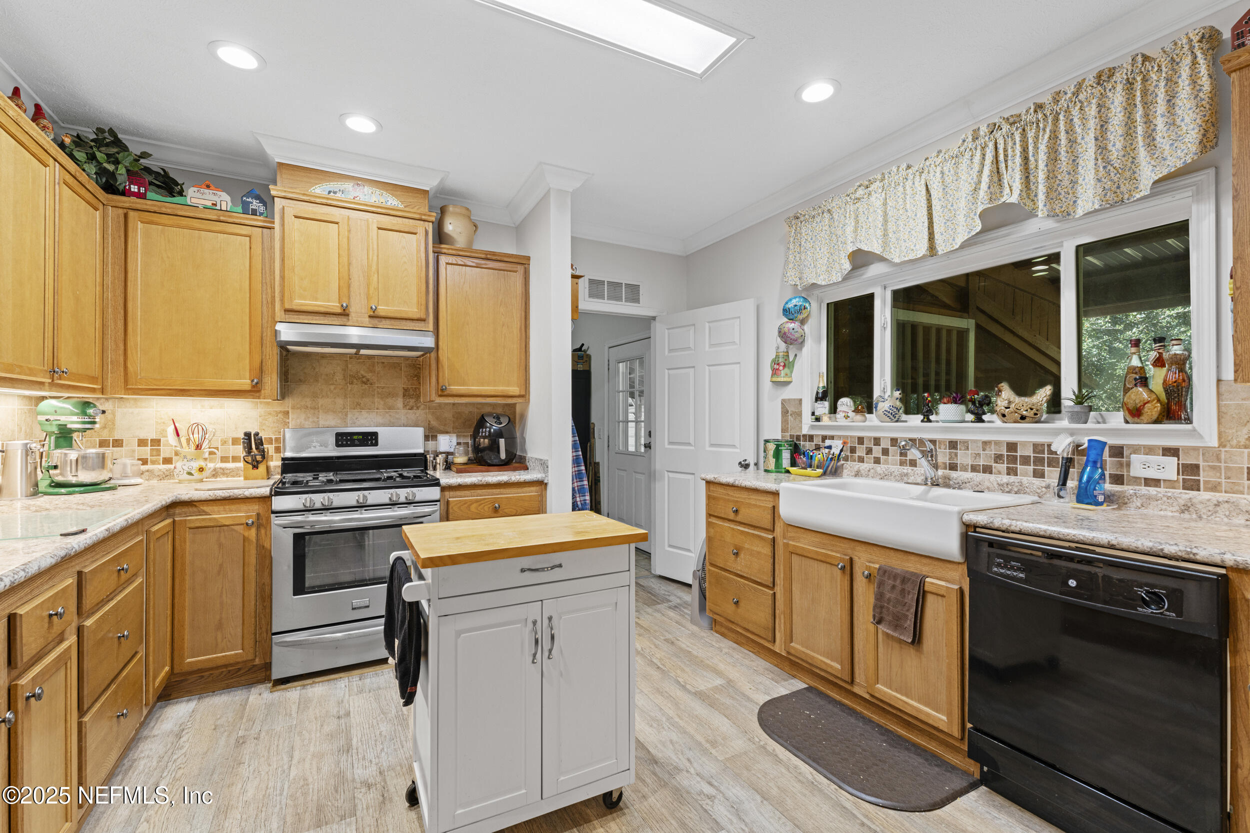 1463 Bardin Road Palatka, FL 32177 - Photo 18 of 61 a kitchen with stainless steel appliances granite countertop a sink stove and refrigerator