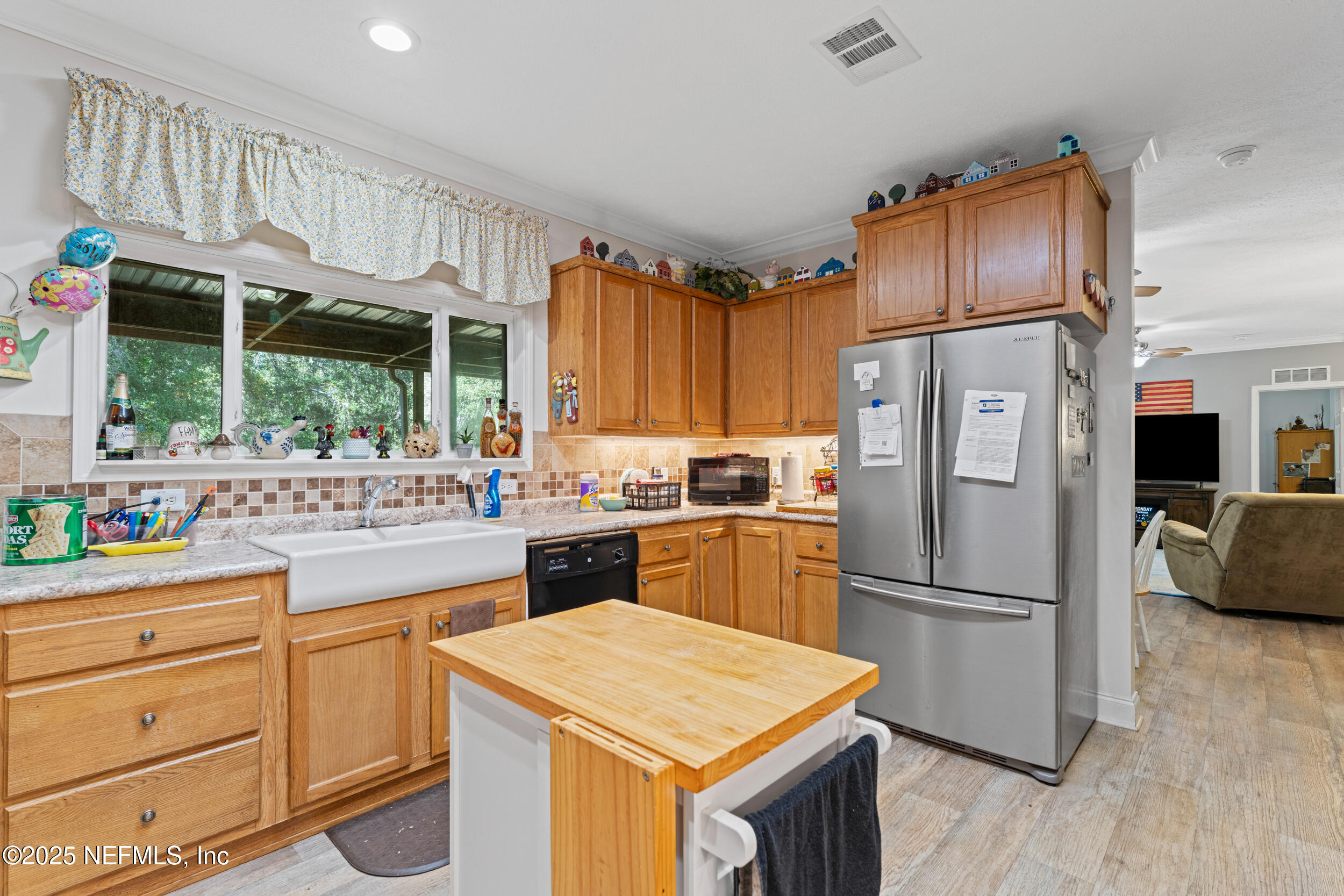 1463 Bardin Road Palatka, FL 32177 - Photo 19 of 61 a kitchen with white cabinets and stainless steel appliances