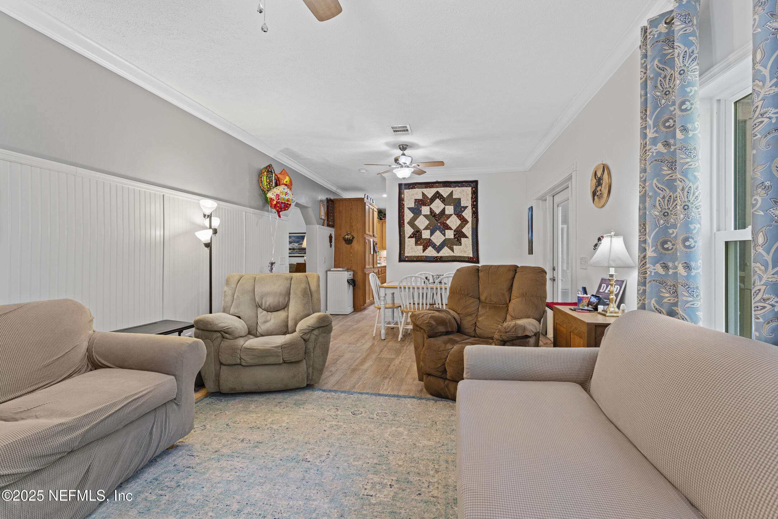 1463 Bardin Road Palatka, FL 32177 - Photo 22 of 61 a living room with furniture and a chandelier