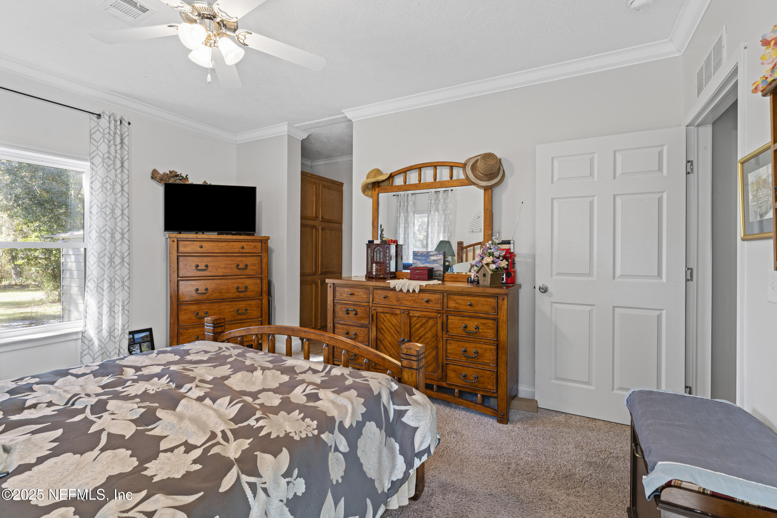 1463 Bardin Road Palatka, FL 32177 - Photo 31 of 61 a bedroom with a bed and a television