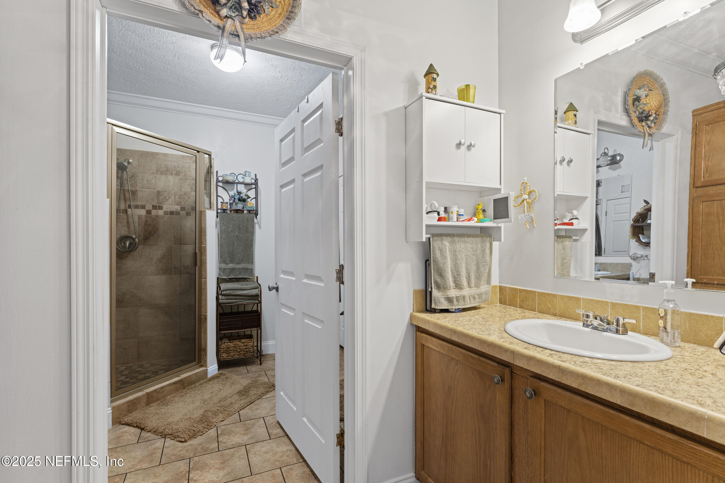 1463 Bardin Road Palatka, FL 32177 - Photo 32 of 61 a bathroom with a granite countertop sink and a mirror