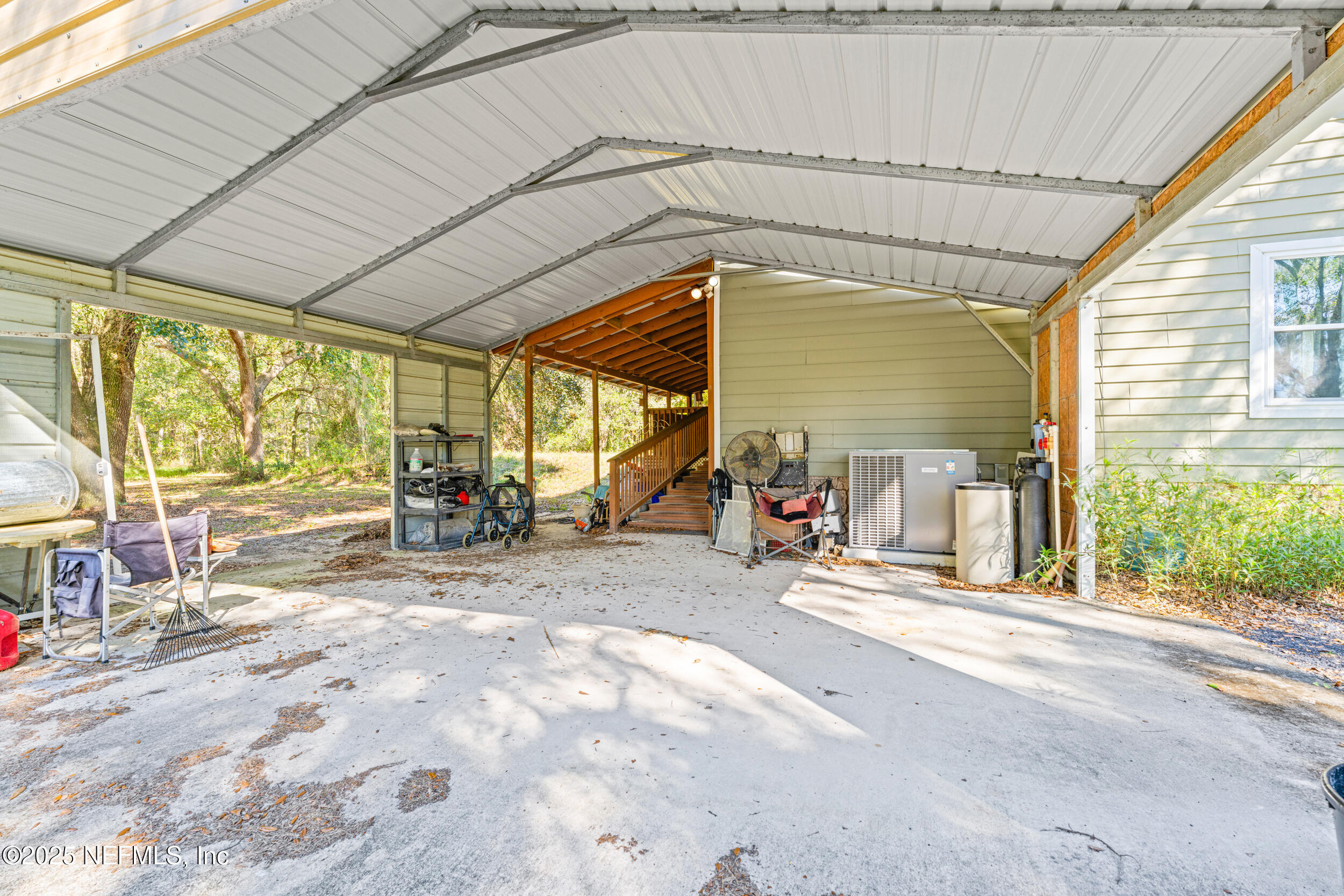 1463 Bardin Road Palatka, FL 32177 - Photo 46 of 61 a view of a patio with table and chairs under an umbrella