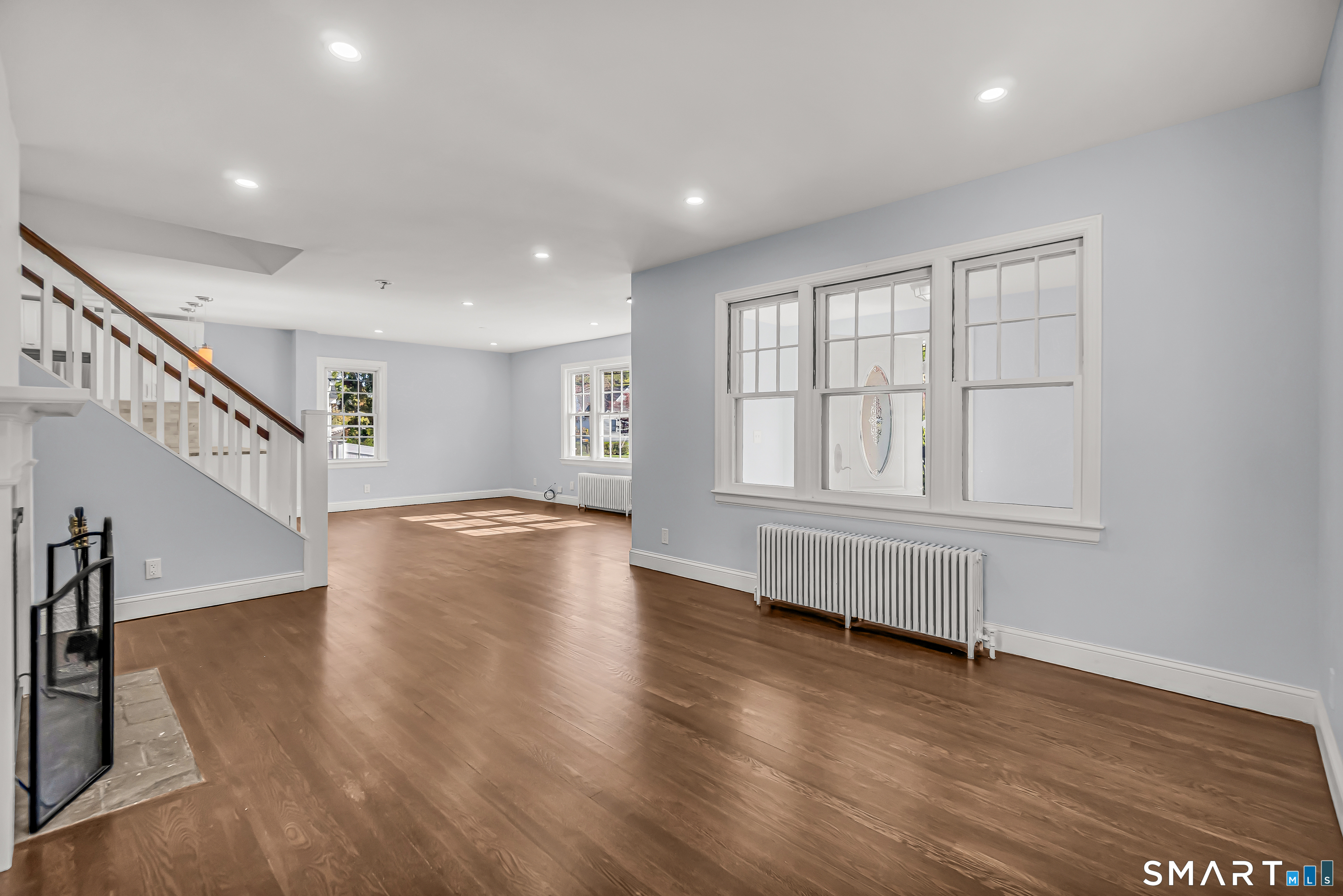 1770 Stratfield Road Fairfield, CT 06825 - Photo 8 of 40 a view of an empty room with wooden floor and staircase