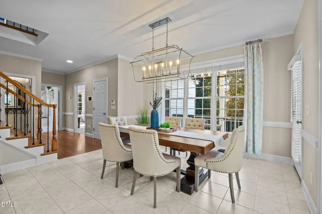 a view of a dining room with furniture wooden floor and chandelier