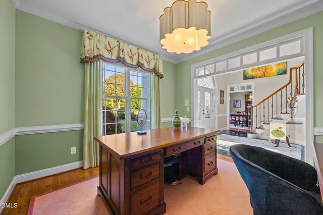 a bedroom with a bed a window and a chandelier