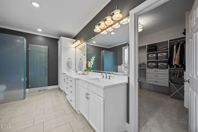 a bathroom with a sink vanity and a mirror