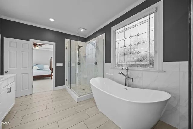 a bedroom with a bed and a large window