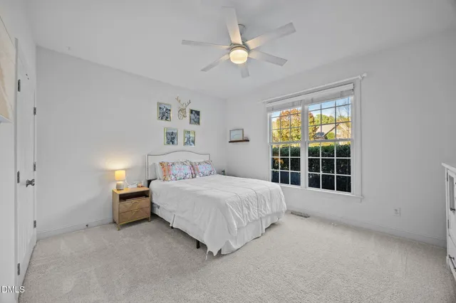 a bathroom with a granite countertop sink a toilet and a mirror