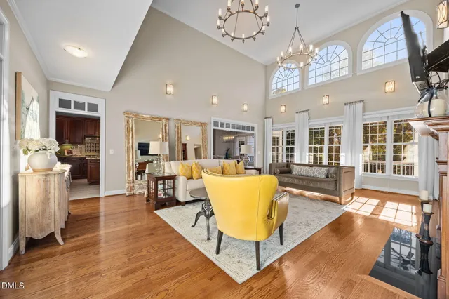 a view of a dining room with furniture a chandelier and wooden floor