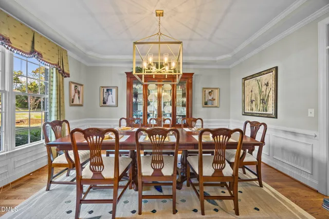 a view of a dining room with furniture wooden floor and chandelier