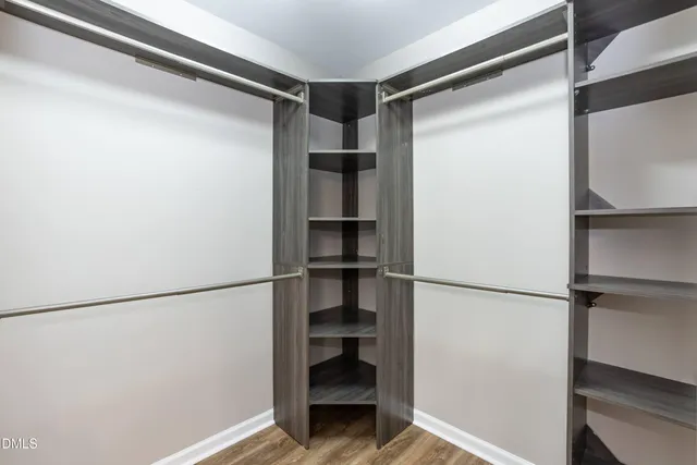 a view of walk in closet with empty racks