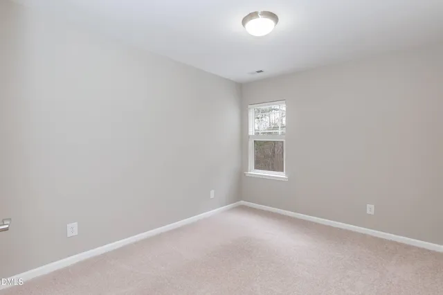 a view of house with backyard and sitting area