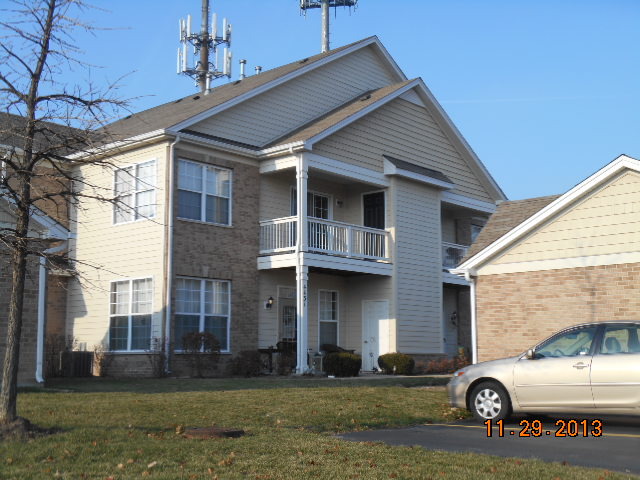 4425 Timber Ridge Court, Unit 117 Joliet, IL 60431 - Photo 2 of 10 a view of a car parked front of a house