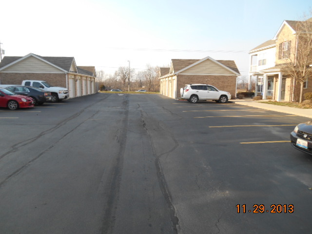 4425 Timber Ridge Court, Unit 117 Joliet, IL 60431 - Photo 3 of 10 a car parked in front of a house