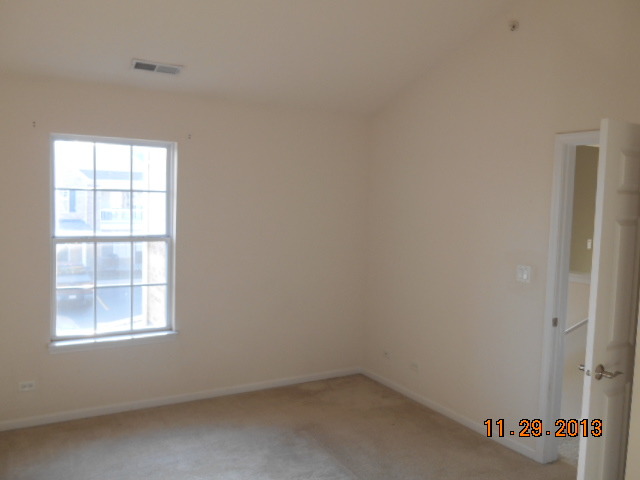 4425 Timber Ridge Court, Unit 117 Joliet, IL 60431 - Photo 8 of 10 an empty room with a window