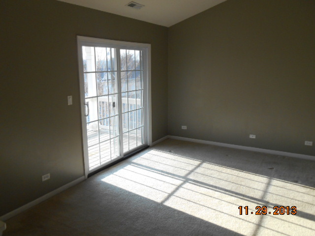 4425 Timber Ridge Court, Unit 117 Joliet, IL 60431 - Photo 9 of 10 a view of an empty room and window