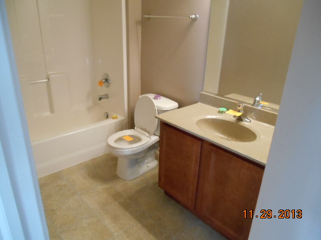 4425 Timber Ridge Court, Unit 117 Joliet, IL 60431 - Photo 10 of 10 a bathroom with a sink toilet and shower