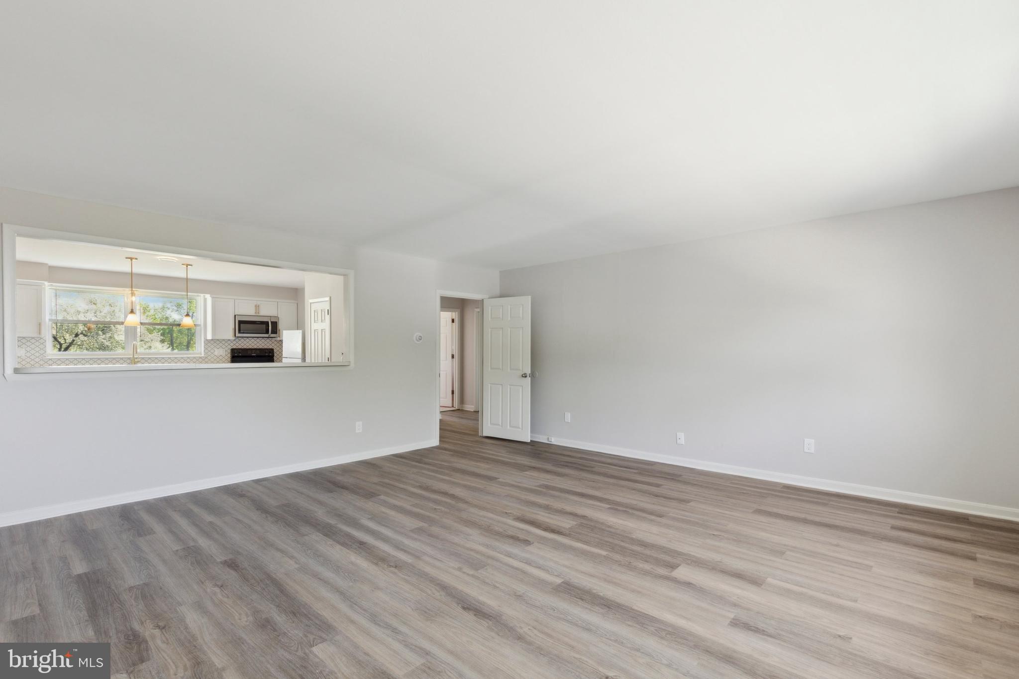 500 Manor House Lane, Unit B3 Willow Grove, PA 19090 - Photo 4 of 10 a view of an empty room with wooden floor and a window