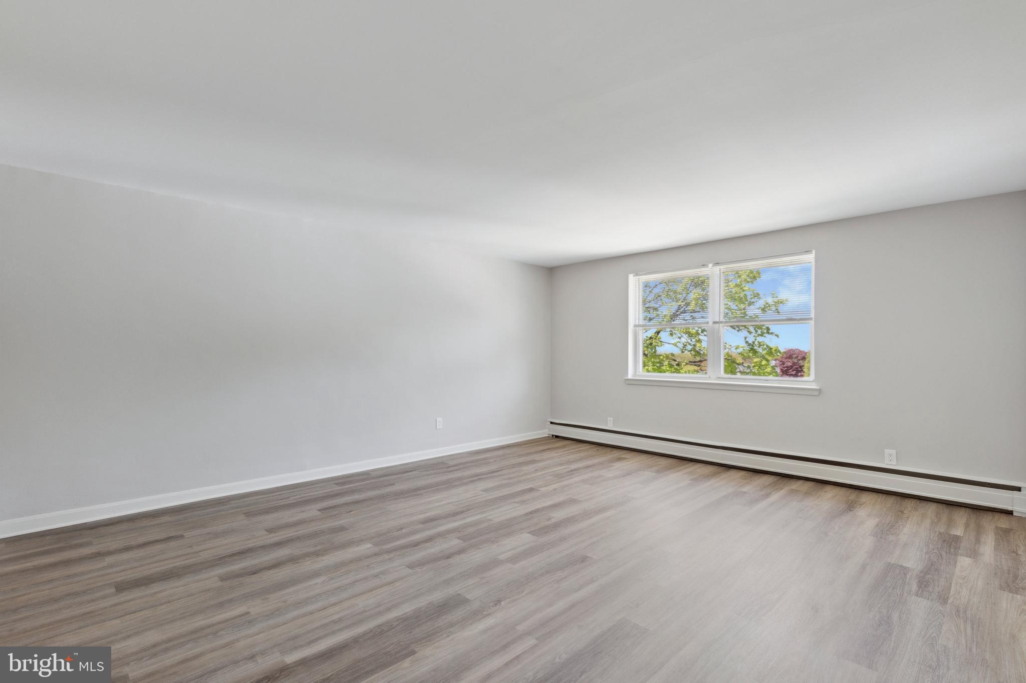 500 Manor House Lane, Unit B3 Willow Grove, PA 19090 - Photo 5 of 10 an empty room with wooden floor and windows