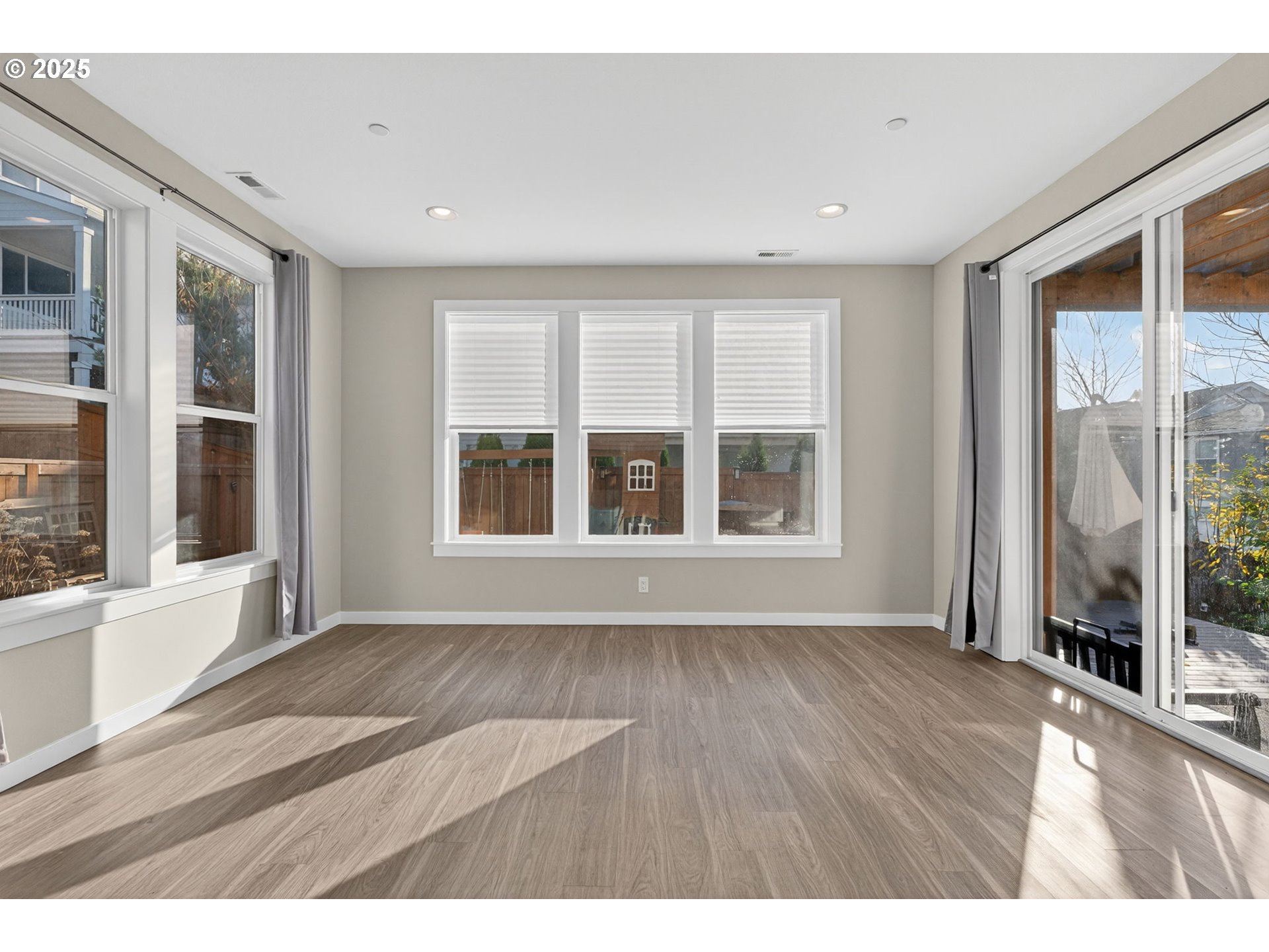 9863 Southwest Ridge Drive Beaverton, OR 97007 - Photo 18 of 48 a view of an empty room with a window and wooden floor