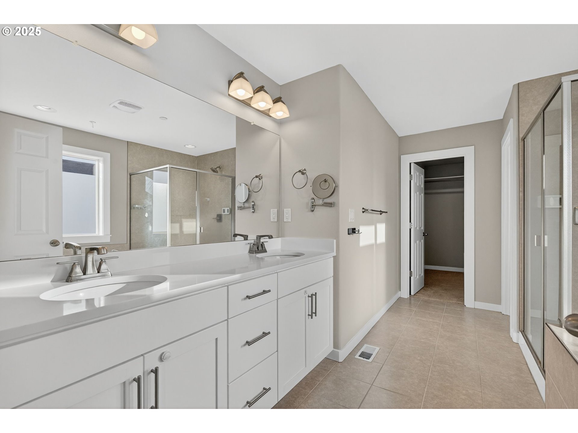 9863 Southwest Ridge Drive Beaverton, OR 97007 - Photo 26 of 48 a spacious bathroom with a double vanity sink a mirror and a shower