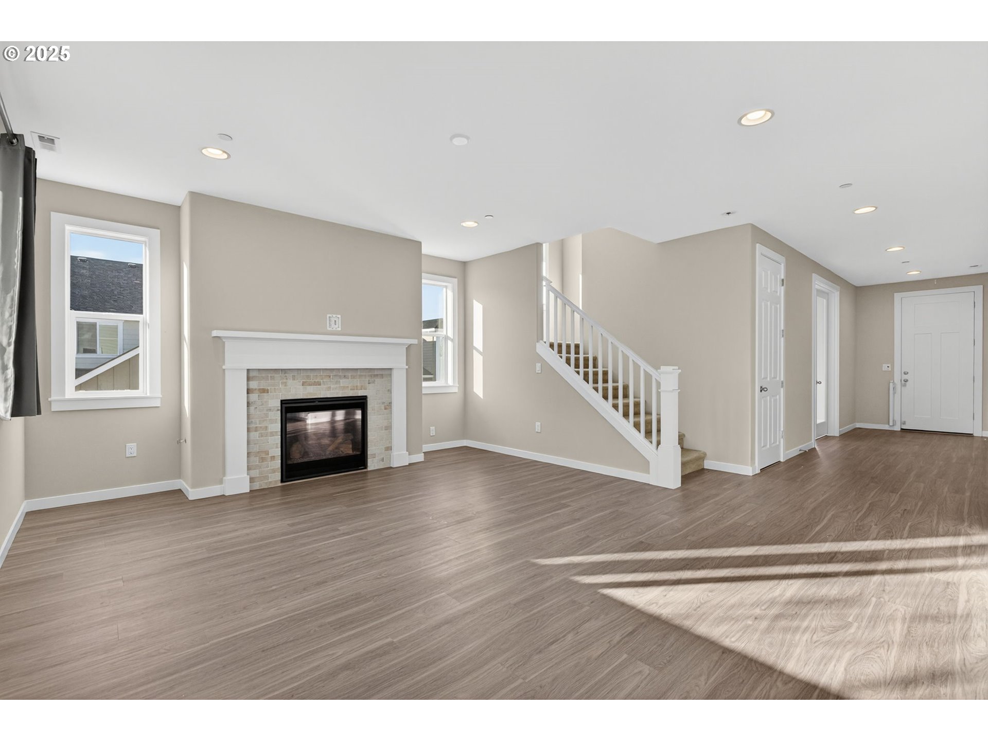 9863 Southwest Ridge Drive Beaverton, OR 97007 - Photo 6 of 48 a view interior of a house with wooden floor fireplace and windows