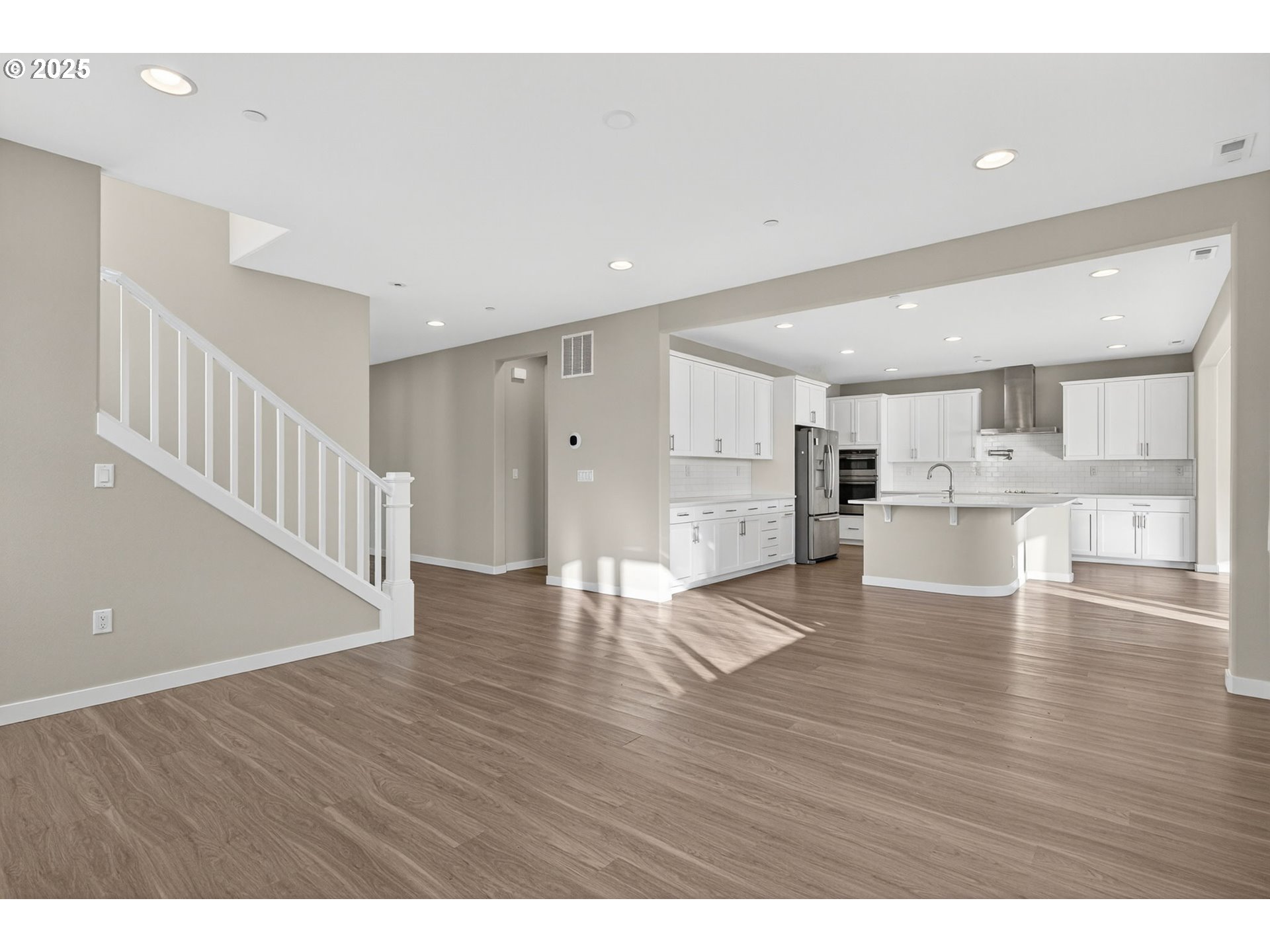 9863 Southwest Ridge Drive Beaverton, OR 97007 - Photo 7 of 48 a view of an empty room with wooden floor