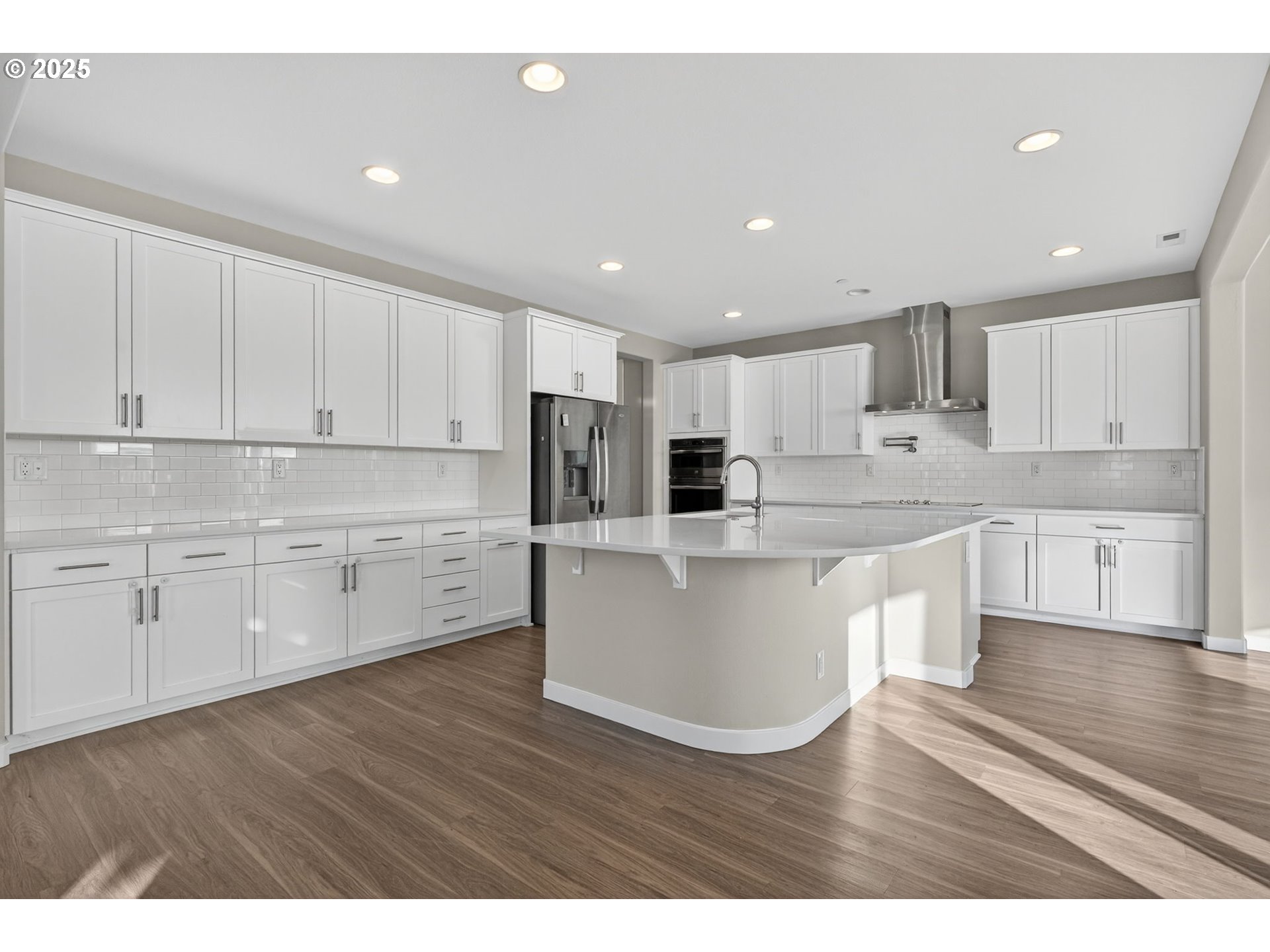 9863 Southwest Ridge Drive Beaverton, OR 97007 - Photo 8 of 48 a open kitchen with white cabinets a sink and wooden floors