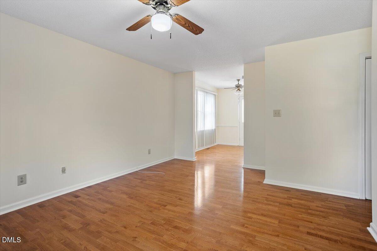 4208 Bluewing Road Raleigh, NC 27616 - Photo 7 of 21 a view of empty room with wooden floor