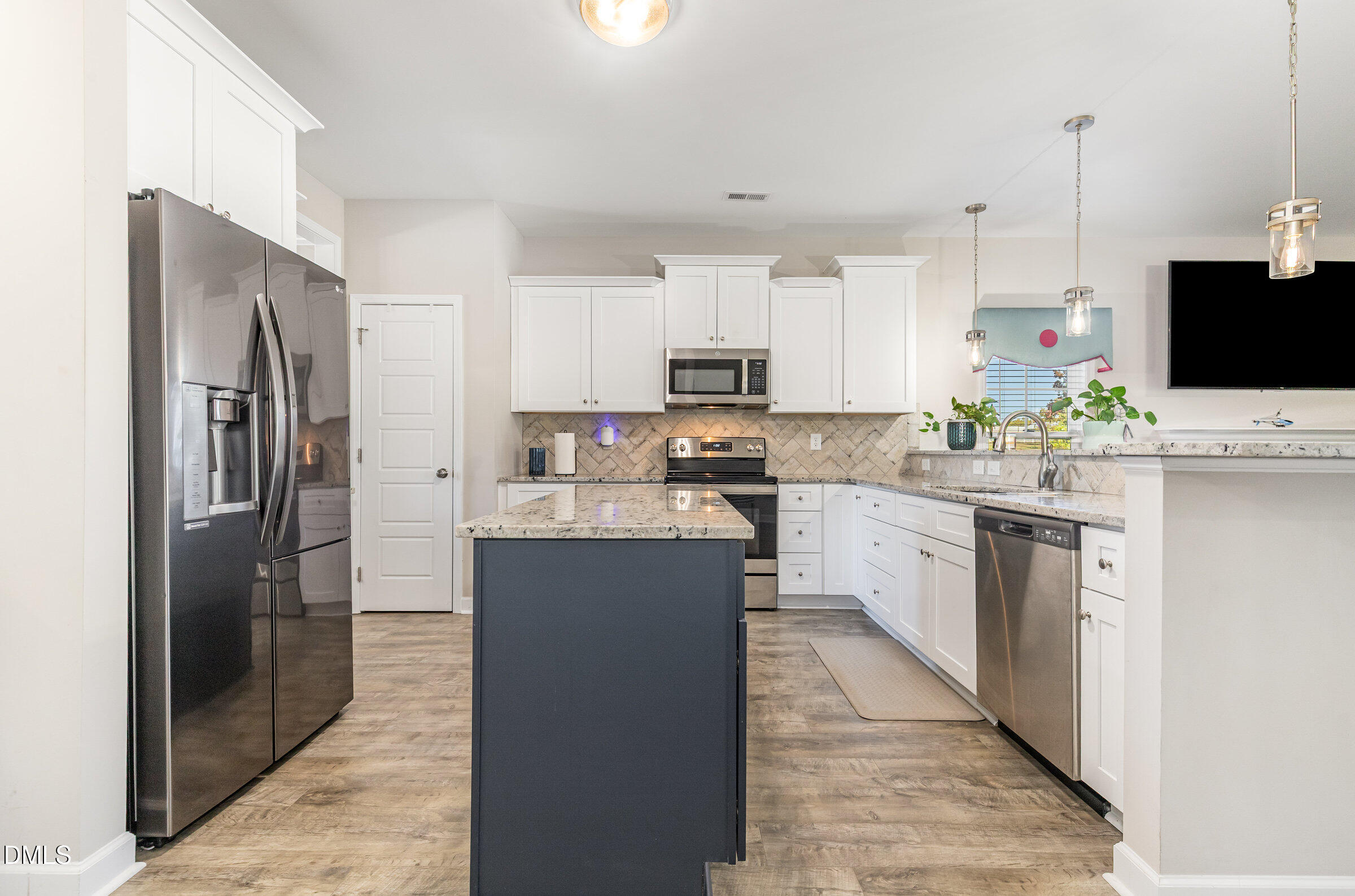 8662 Buckhorn Plantation Road Sims, NC 27880 - Photo 12 of 40 a kitchen with stainless steel appliances granite countertop a refrigerator a stove a sink and a microwave