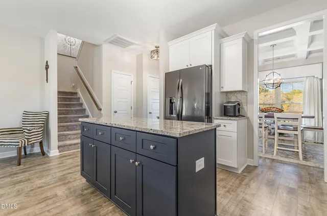 a kitchen with stainless steel appliances granite countertop a refrigerator a stove a sink and a microwave