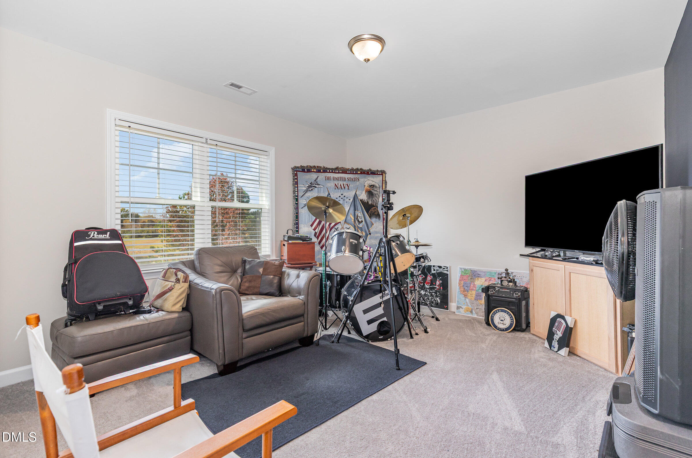8662 Buckhorn Plantation Road Sims, NC 27880 - Photo 18 of 40 a living room with furniture a flat screen tv and a window
