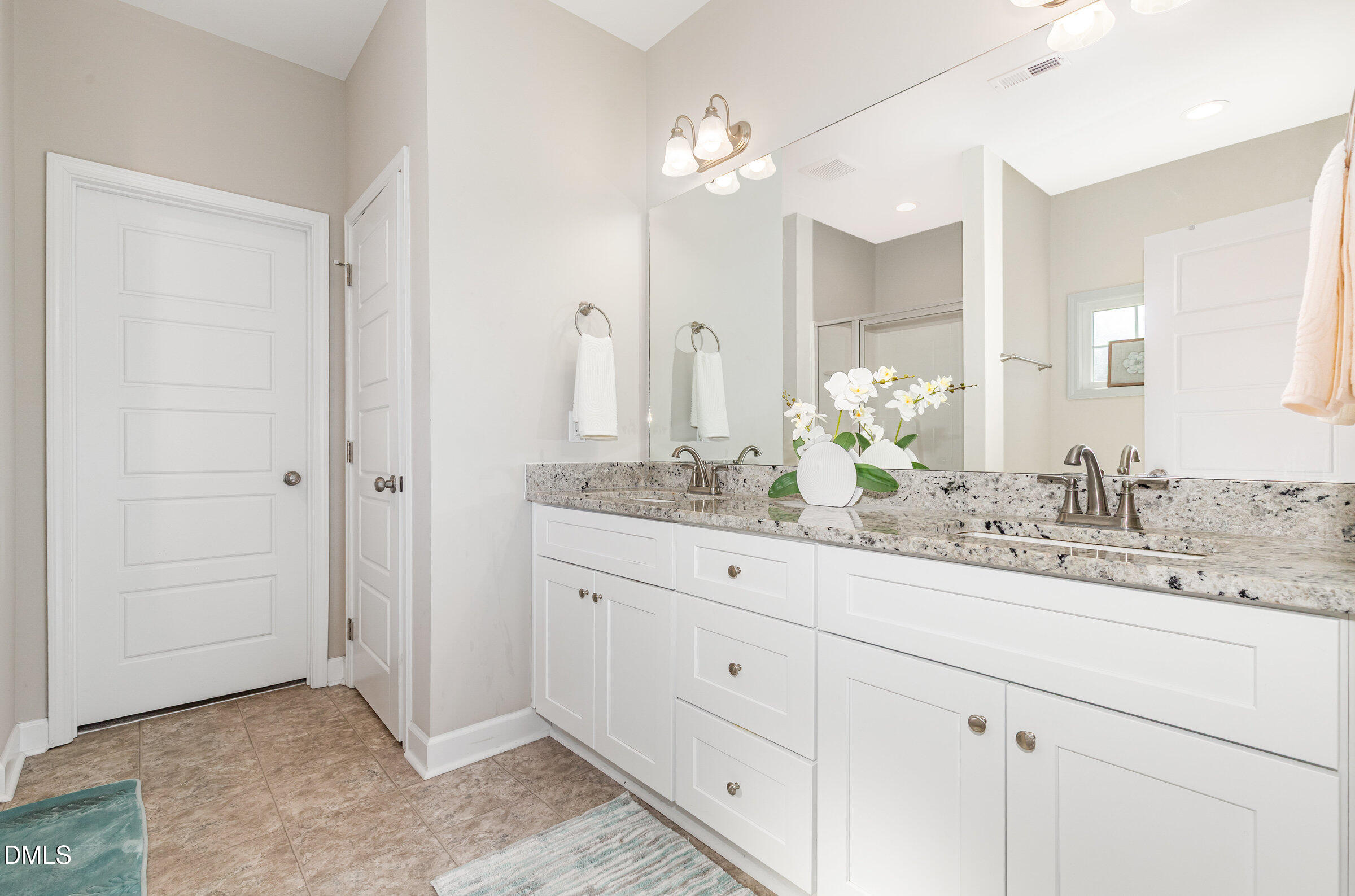 8662 Buckhorn Plantation Road Sims, NC 27880 - Photo 21 of 40 a bathroom with double sink and a mirror