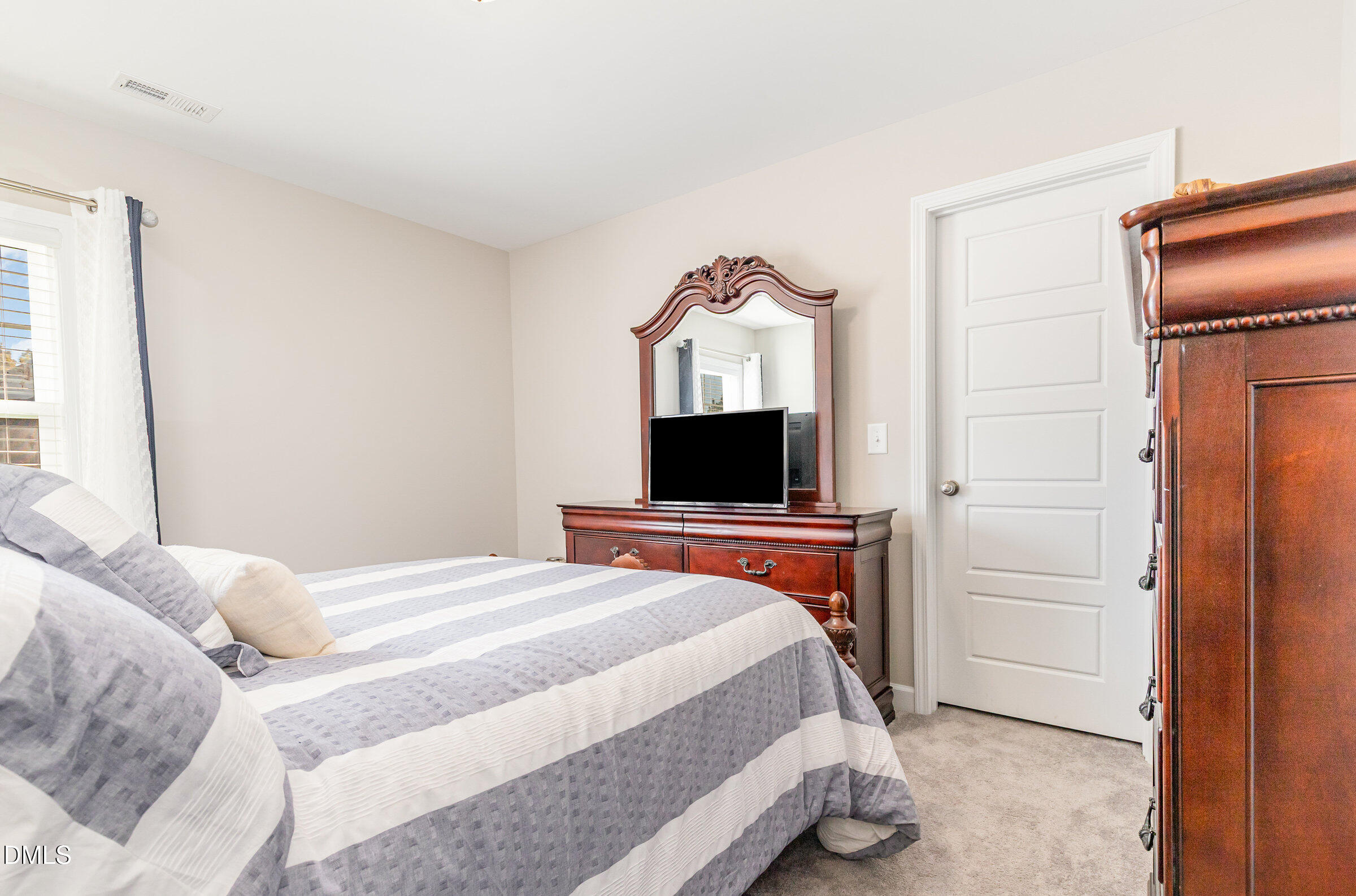 8662 Buckhorn Plantation Road Sims, NC 27880 - Photo 23 of 40 a bedroom with a bed and a television