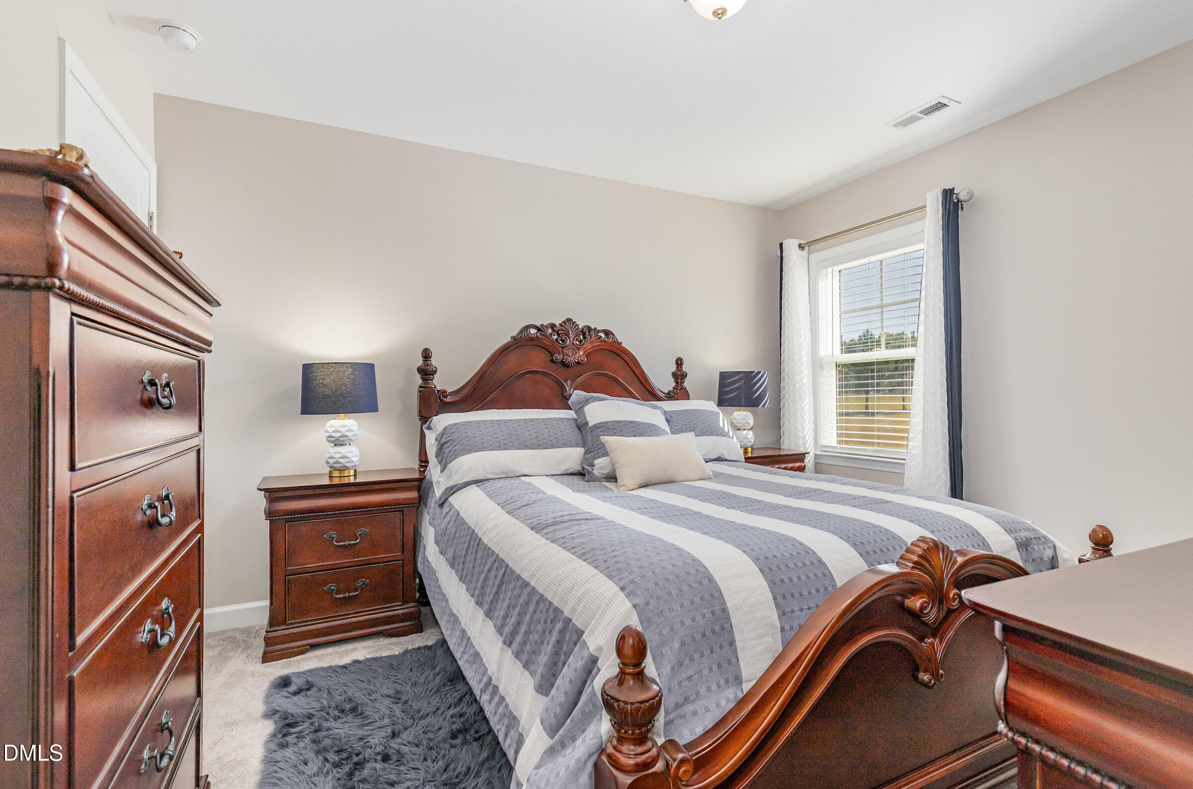 8662 Buckhorn Plantation Road Sims, NC 27880 - Photo 24 of 40 a bedroom with a bed and a dresser