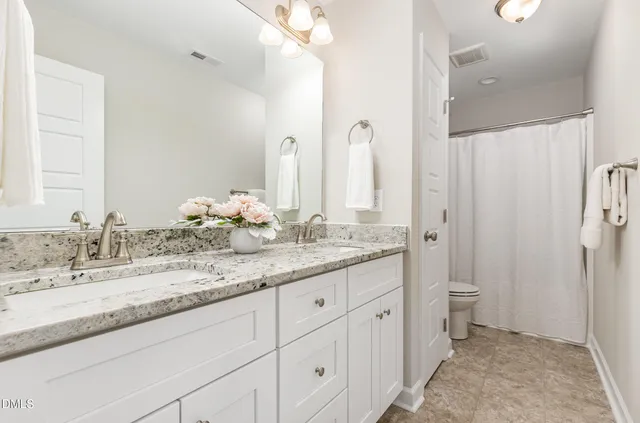 a bedroom with a bed and a television