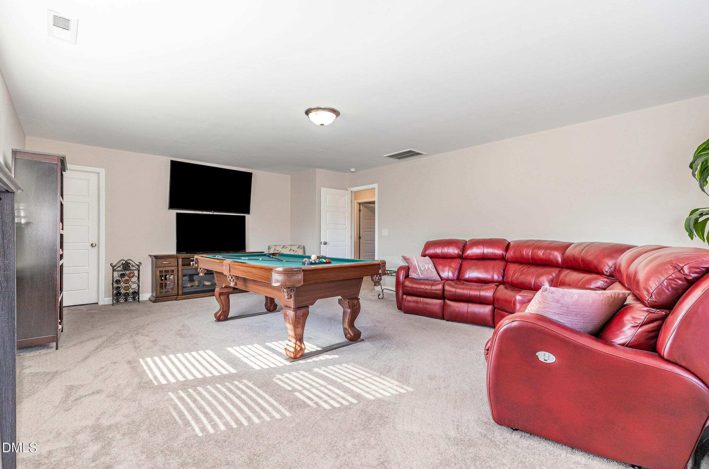 8662 Buckhorn Plantation Road Sims, NC 27880 - Photo 31 of 40 a living room with furniture a flat screen tv and a large window