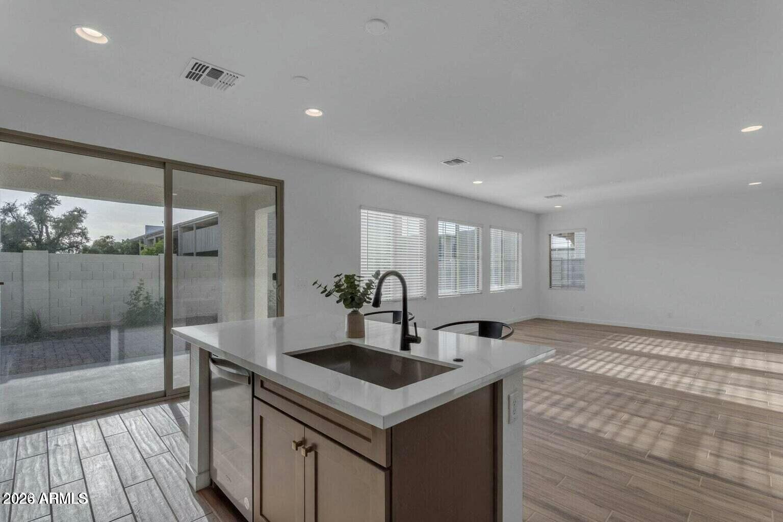 6434 North 17th Street Phoenix, AZ 85016 - Photo 16 of 38 a kitchen with stainless steel appliances granite countertop a sink and wooden floor