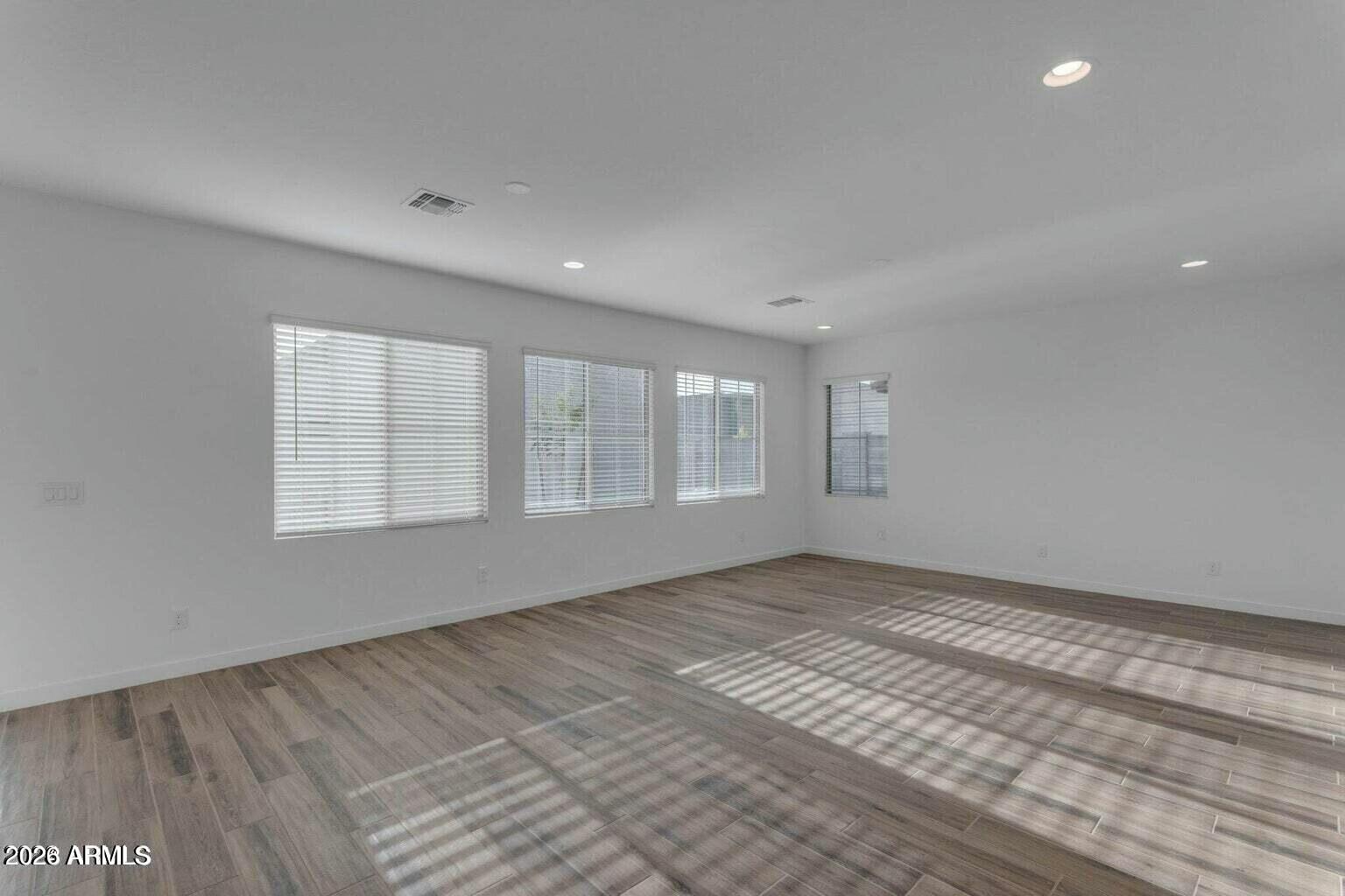 6434 North 17th Street Phoenix, AZ 85016 - Photo 17 of 38 a view of an empty room with wooden floor and a window