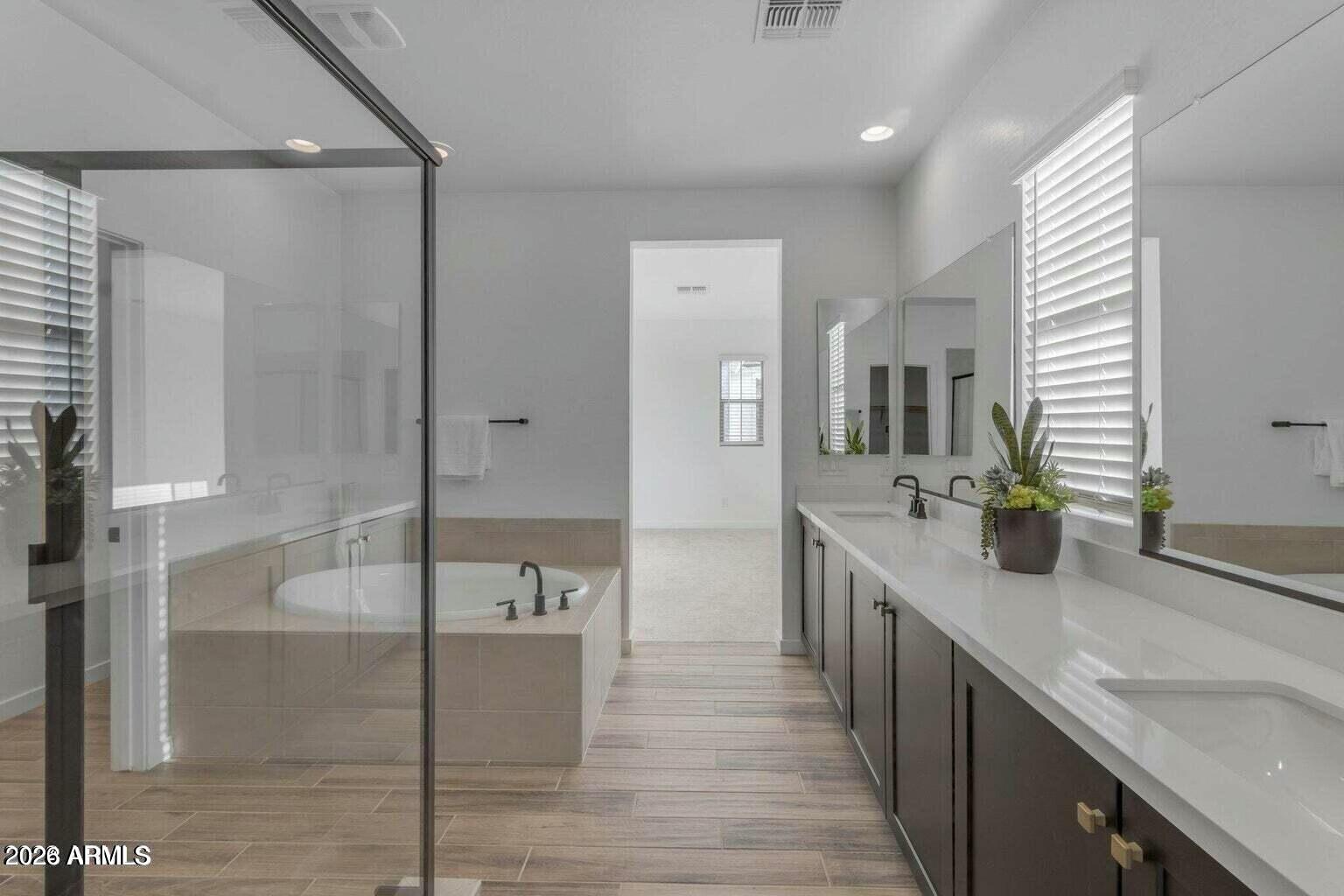 6434 North 17th Street Phoenix, AZ 85016 - Photo 5 of 38 a large bathroom with a double vanity sink a mirror and a shower