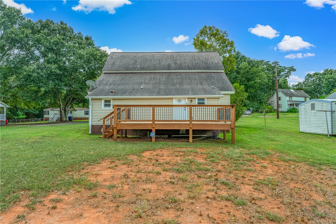 47 Square Street Pelzer, SC 29669 - Photo 4 of 29 A spacious wooden deck overlooks the grassy backyard of this traditional residence.