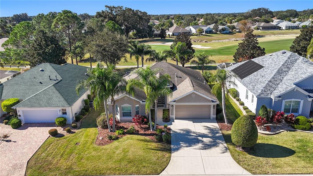 an aerial view of a house with garden space and ocean view
